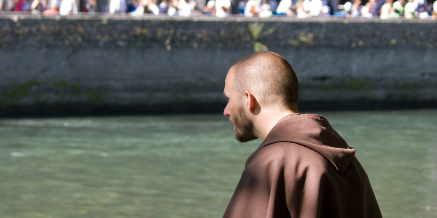 carmelite-friar-praying-beside-on-the-riverbank-across-from-the-grotte-de-massabielle-blogfeatimage-1773106705.webp